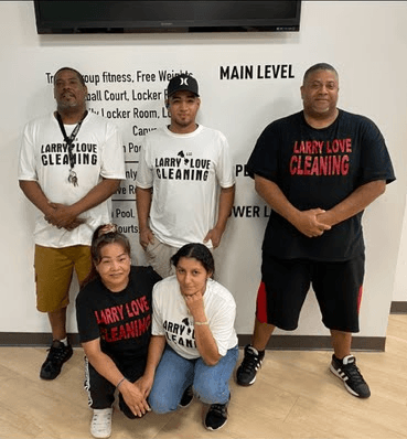 Image of the Larry Love Cleaning team standing together, smiling and wearing company uniforms